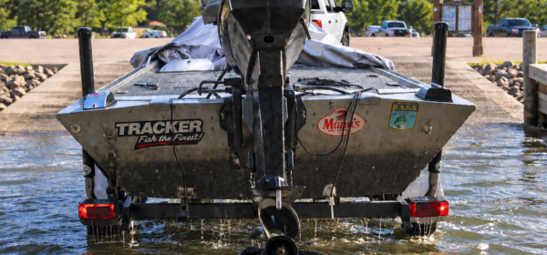 Hard to Load Your Boat? Boat being loading on a trailer at a dock.